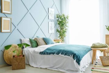 A modern, boho bedroom design with a splash of teal and wood elements for a natural look. There's a lot of natural light.