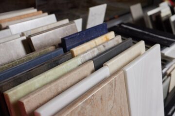 A display of various stone kitchen counter options. There are various colors visible, including blue, yellow, and grey.
